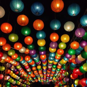 Colorful Chinese lanterns hanging over a tunnel.