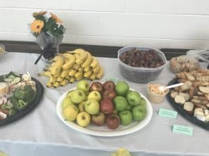 Fruit on a table with flowers.